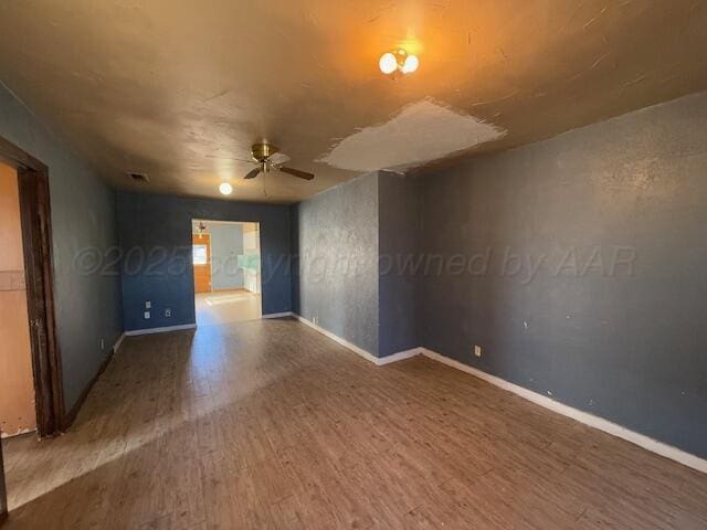 unfurnished room with wood-type flooring and ceiling fan