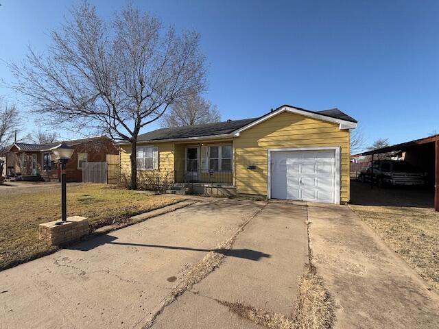 ranch-style house with a garage and a front yard