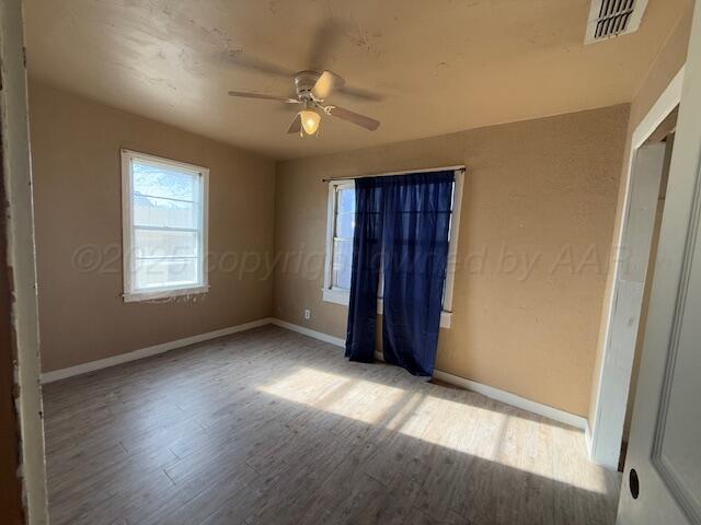 unfurnished bedroom featuring hardwood / wood-style floors and ceiling fan