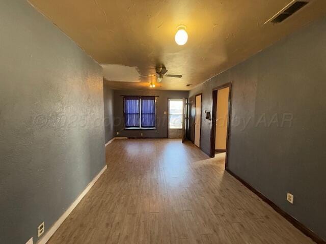 spare room with hardwood / wood-style flooring and ceiling fan