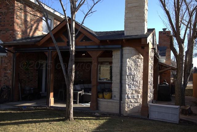 back of property featuring a yard and a patio area