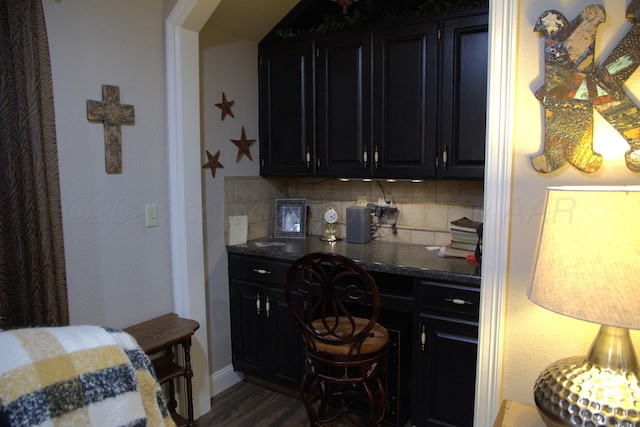 kitchen with dark wood-type flooring and decorative backsplash