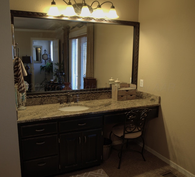 bathroom featuring crown molding and vanity