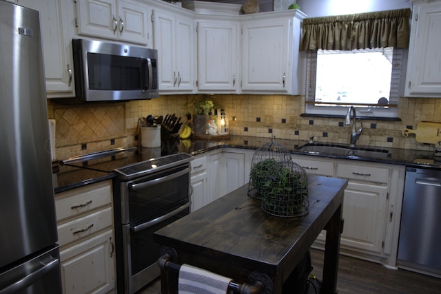 kitchen with white cabinetry, appliances with stainless steel finishes, and sink