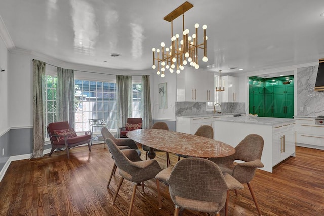 2411 S Lipscomb St, Amarillo, TX 79109 - dining space featuring wood finished floors, a chandelier, ornamental molding, and baseboards