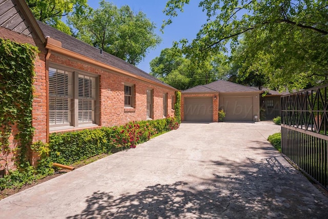 2411 S Lipscomb St, Amarillo, TX 79109 - view of home's exterior featuring an outdoor structure, a detached garage, and brick siding