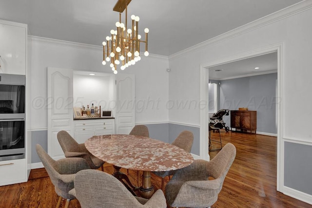 2411 S Lipscomb St, Amarillo, TX 79109 - dining room featuring crown molding, wood finished floors, a chandelier, and baseboards