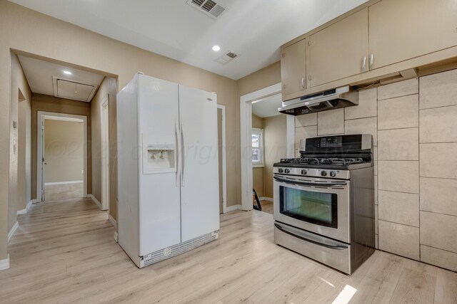 234 N Birge Ave, Dumas, TX 79029 - kitchen with white fridge with ice dispenser, stainless steel range with gas cooktop, under cabinet range hood, light wood-style flooring, and recessed lighting