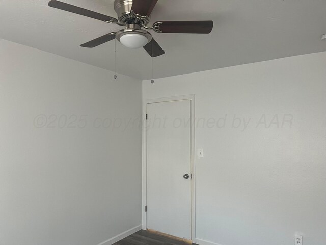 1902 Rogers St, Amarillo, TX 79106 - unfurnished room with baseboards, a ceiling fan, and dark wood-type flooring