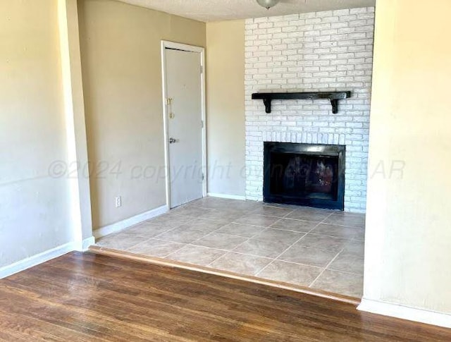 unfurnished living room with a fireplace and hardwood / wood-style floors