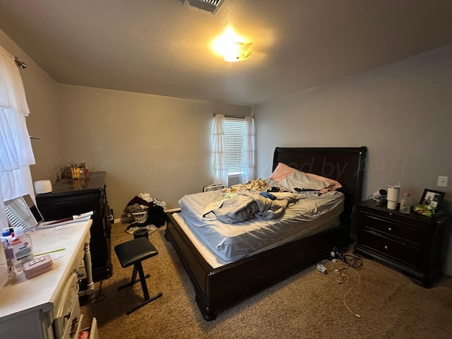 carpeted bedroom with visible vents and baseboards