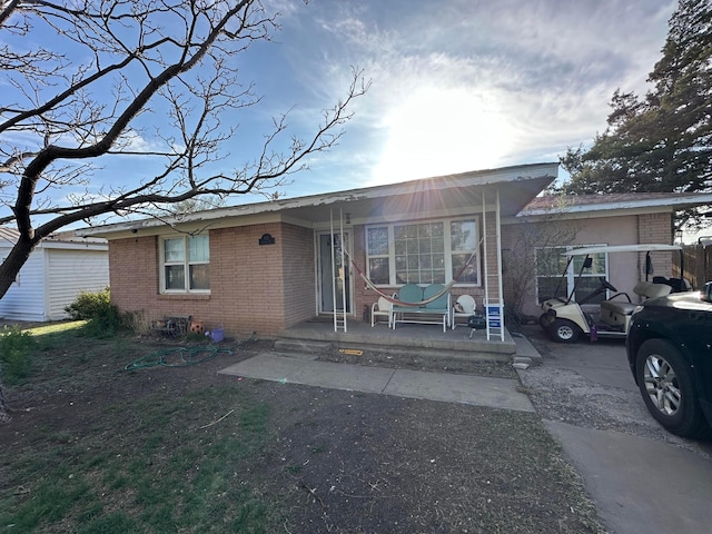 view of front of house with covered porch and brick siding