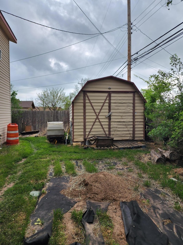 view of shed featuring fence