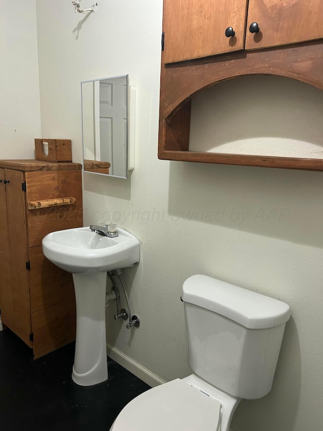 1026 S Eastern St, Amarillo, TX 79104 - bathroom with toilet, baseboards, and a sink