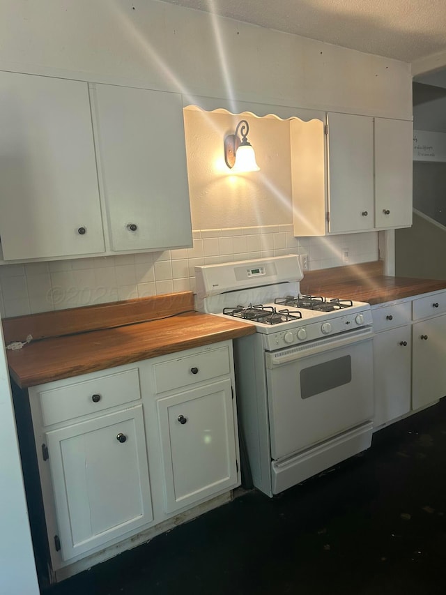 kitchen featuring white cabinetry, butcher block countertops, and gas range gas stove