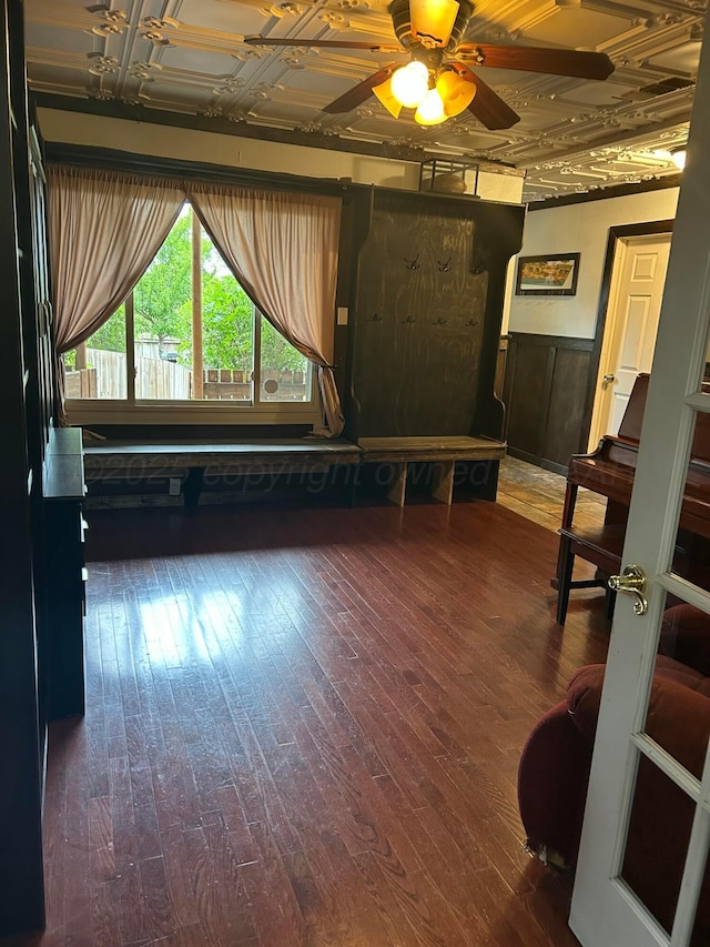 1026 S Eastern St, Amarillo, TX 79104 - unfurnished living room featuring a wainscoted wall, a ceiling fan, wood finished floors, and an ornate ceiling