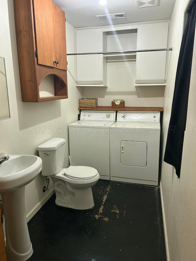 1026 S Eastern St, Amarillo, TX 79104 - half bath with independent washer and dryer, baseboards, toilet, a sink, and concrete floors