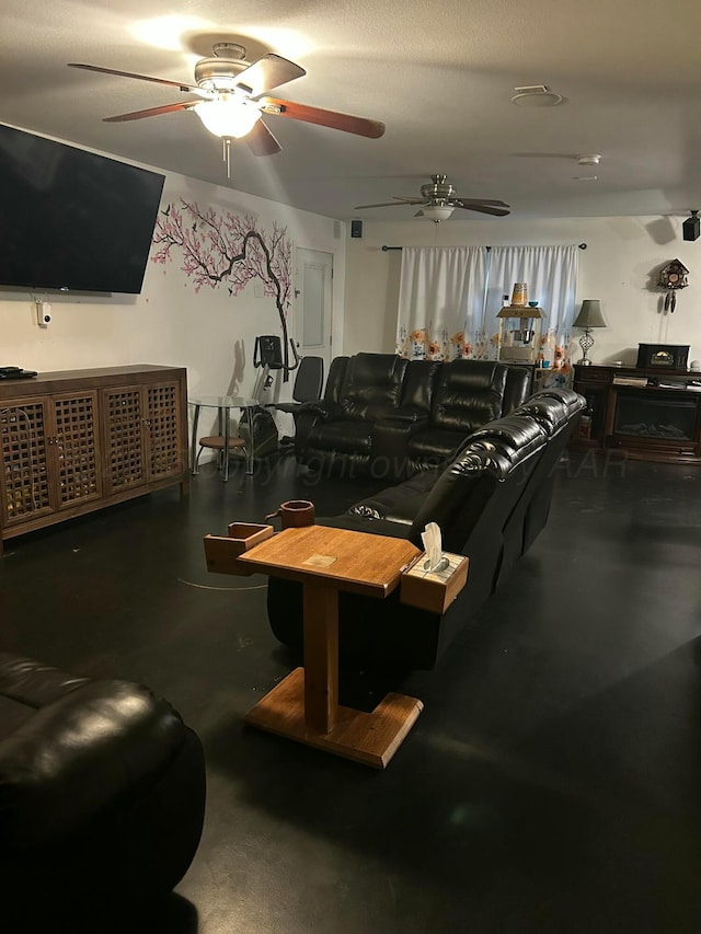 living area featuring a ceiling fan and finished concrete flooring
