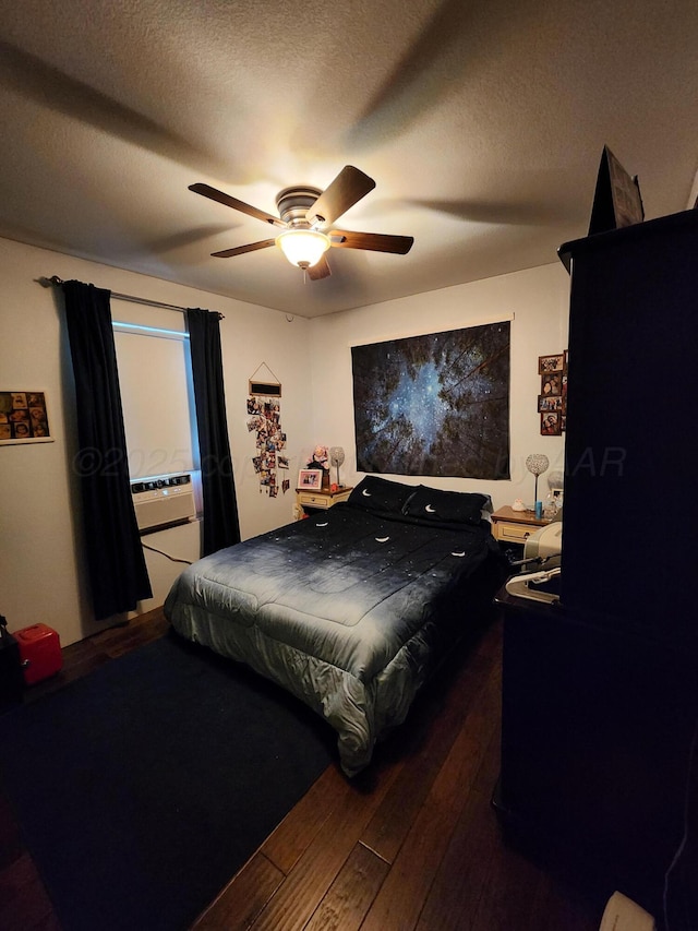 bedroom with a ceiling fan, a textured ceiling, and hardwood / wood-style flooring