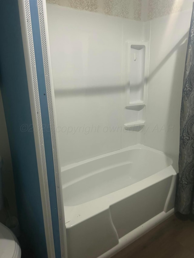 1026 S Eastern St, Amarillo, TX 79104 - full bathroom featuring wood finished floors and shower / bathtub combination with curtain