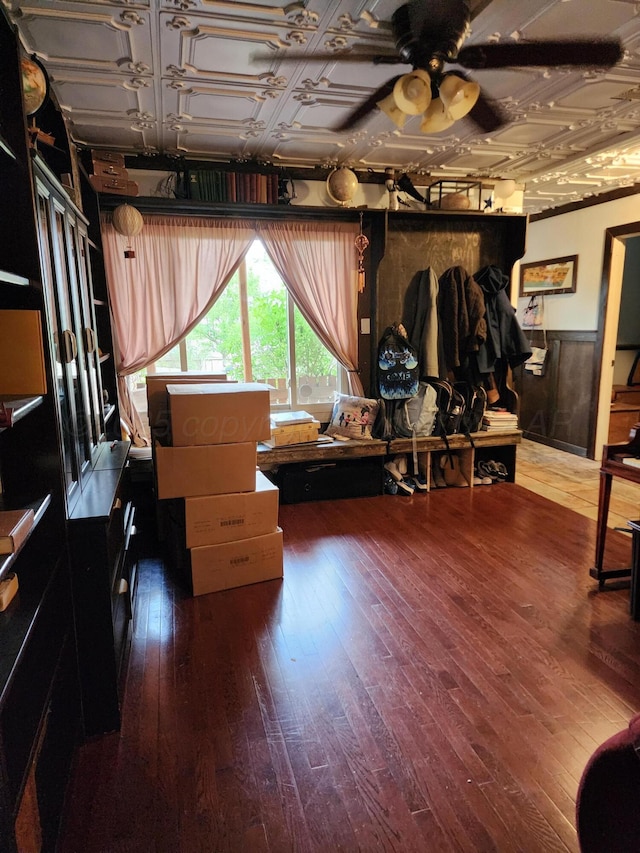 bedroom featuring a wainscoted wall and hardwood / wood-style floors