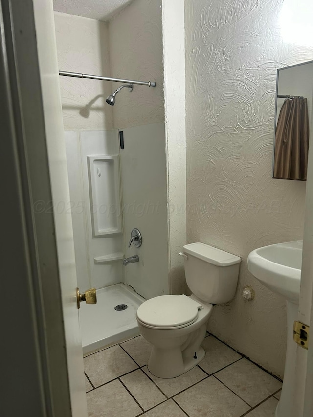 1026 S Eastern St, Amarillo, TX 79104 - full bathroom with a stall shower, tile patterned flooring, toilet, and a sink
