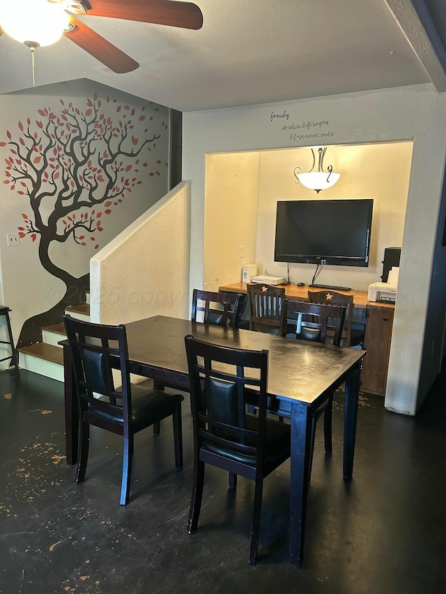 dining area featuring stairs, ceiling fan, and finished concrete floors