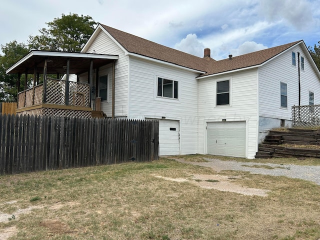 view of side of home with a garage and a yard