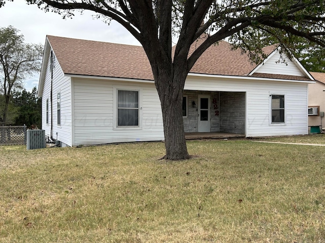 back of property with a patio area, cooling unit, and a yard