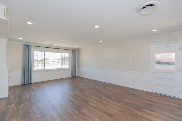 empty room featuring dark wood-type flooring and crown molding