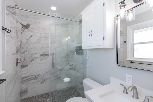 bathroom featuring walk in shower, vanity, and toilet