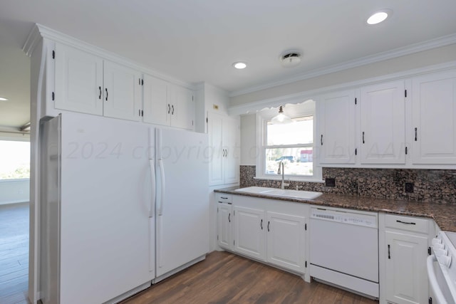 kitchen featuring dark wood-type flooring, sink, crown molding, white cabinetry, and white appliances