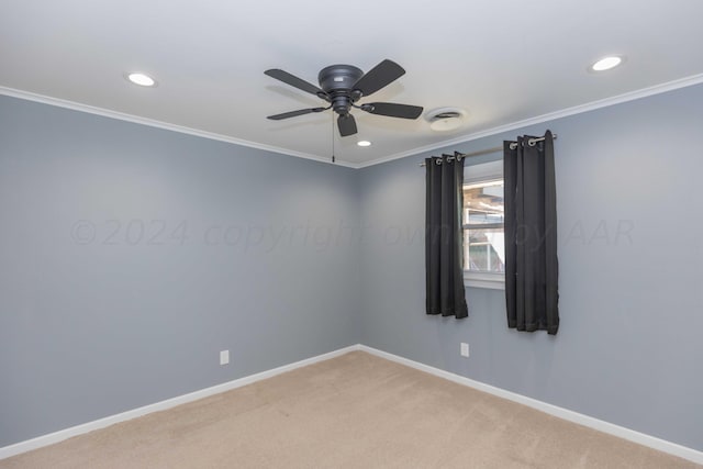 spare room featuring ceiling fan, carpet floors, and ornamental molding