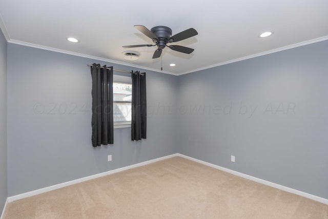 carpeted spare room with ceiling fan and crown molding