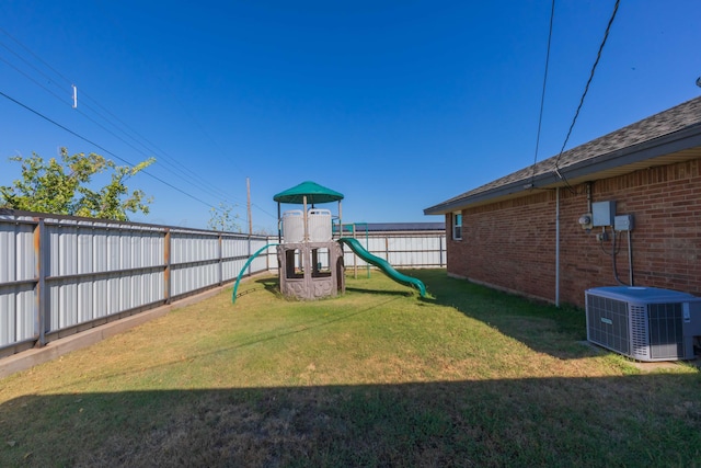 view of jungle gym featuring central AC unit and a lawn