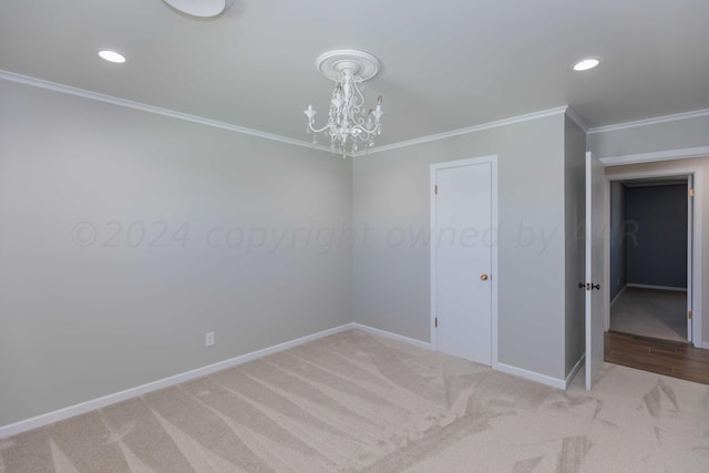 carpeted spare room with crown molding and a notable chandelier