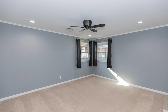 empty room with light carpet, crown molding, and ceiling fan