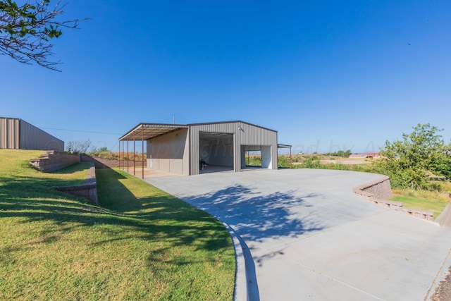 garage with a lawn and a carport