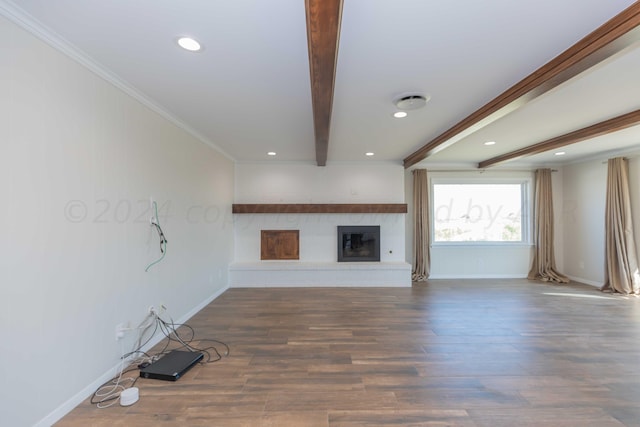 unfurnished living room with dark wood-type flooring, beamed ceiling, and crown molding