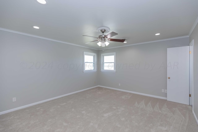 carpeted empty room featuring ceiling fan and crown molding