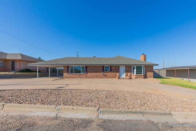 ranch-style house featuring a carport