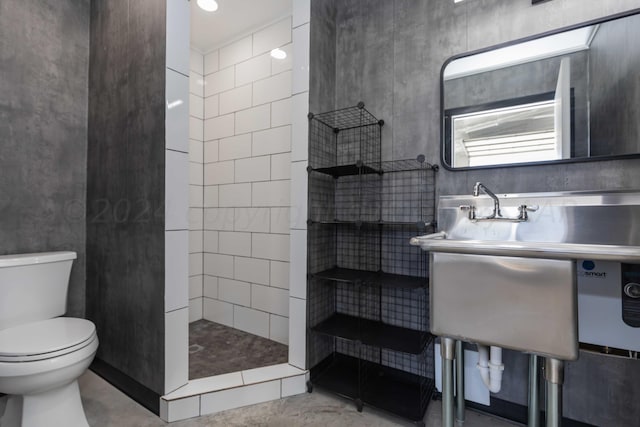 bathroom with tiled shower and toilet