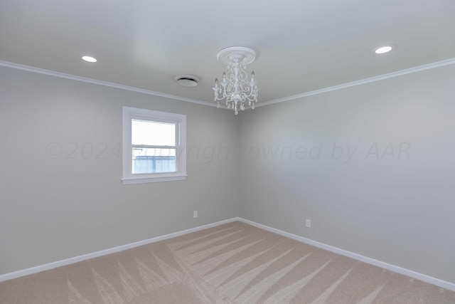 carpeted spare room with ornamental molding and an inviting chandelier