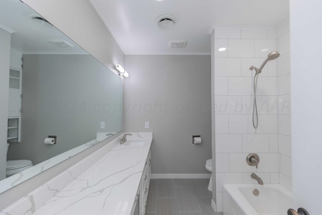 full bathroom with vanity, toilet, crown molding, and tiled shower / bath combo