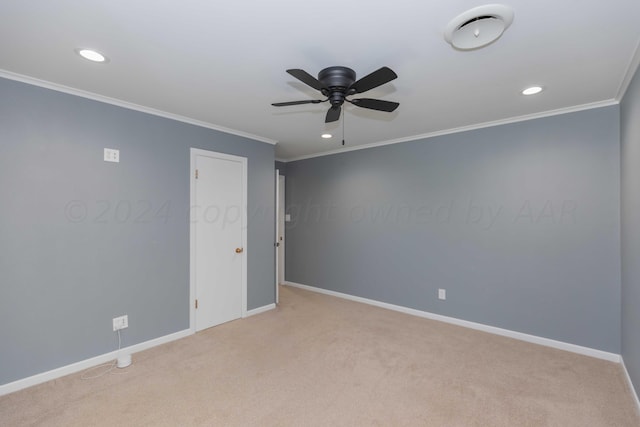 unfurnished room with ceiling fan, light carpet, and crown molding