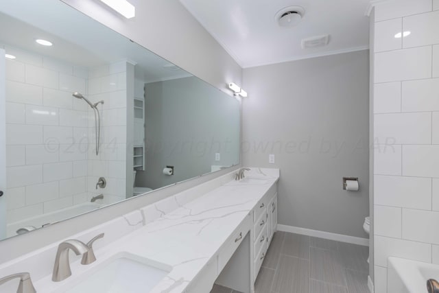 full bathroom featuring toilet, vanity, tiled shower / bath, and ornamental molding