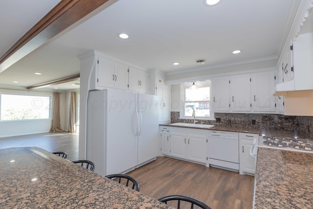 kitchen with white cabinets, sink, ornamental molding, dark hardwood / wood-style floors, and white appliances