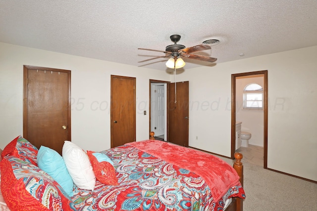 2904 Pittsburg St, Amarillo, TX 79103 - bedroom with carpet floors, two closets, a textured ceiling, connected bathroom, and ceiling fan