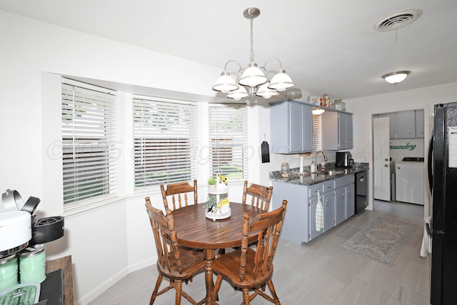 2904 Pittsburg St, Amarillo, TX 79103 - dining area with washer / clothes dryer and a chandelier