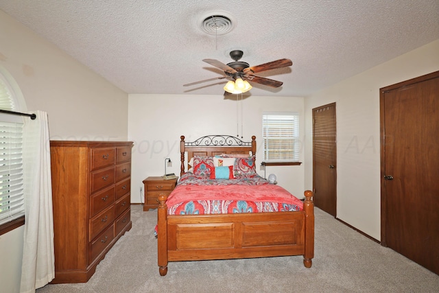 2904 Pittsburg St, Amarillo, TX 79103 - bedroom featuring light colored carpet, a textured ceiling, two closets, and ceiling fan